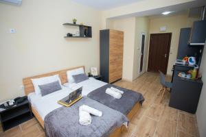a bedroom with a bed with two towels on it at Veliko Turnovo Studios - Stylish & Convenient in Veliko Tŭrnovo +281 photos