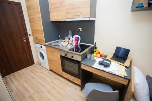 a small kitchen with a desk with a laptop on it at Trendy Studios with FREE PARKING in Veliko Turnovo in Veliko Tŭrnovo