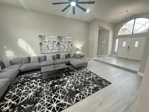 a living room with a couch and a rug at Delightful 4 Bedroom House with Pool! in Las Vegas
