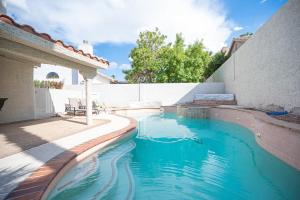 a swimming pool in the backyard of a house at Delightful 4 Bedroom House with Pool! in Las Vegas
