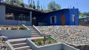 a house with stairs and a blue building at Mendoza, Cacheuta, montaña in Ciudad Lujan de Cuyo