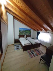 a living room with two beds and a couch at Rustica Complex Borsa in Borşa