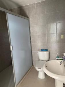 a bathroom with a toilet and a sink at Quinta del Eden, 9PX, Pool, BBQ, Pet Friendly in Matehuala