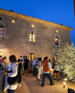 a group of people standing outside of a building at Hotel-Masia Can Farrés in El Bruc