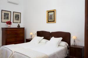 a bedroom with two beds and a dresser at CORTIJO RURAL LA MARISCALA in Jerez de la Frontera +17 photos