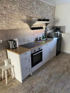 a kitchen with a sink and a stove top oven at Goethestraße in Staßfurt