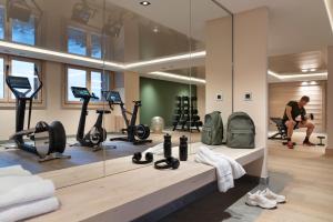 a man in a gym with several exercise equipment at Résidence Manaka in Aime-La Plagne