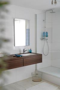 een badkamer met een wastafel en een douche bij Gastenkamers In de Bleick in Rekem