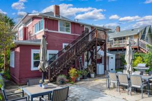 a red house with tables and umbrellas at Unique House 6BR 6 Beds 10 PX Parking in Berkeley