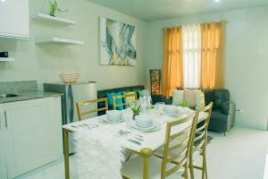 a dining room with a white table and chairs at Matina Pangi Evisa Subdivision 2 bedrooms house with parking wifi Netflix in Davao City