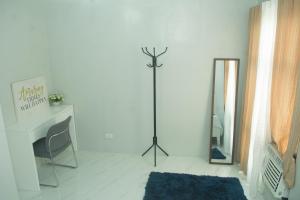 a white room with a mirror and a table and a chair at Matina Pangi Evisa Subdivision 2 bedrooms house with parking wifi Netflix in Davao City