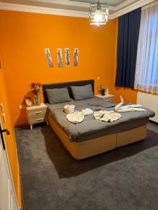 a bedroom with orange walls and a bed with towels on it at Taksim Pandora hotel in Istanbul