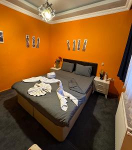 a bedroom with a large bed with orange walls at Taksim Pandora hotel in Istanbul