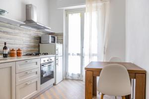 una cocina con una mesa y una silla. en Beautiful Home 'Foeste' - With Parking - by Host4U, en Imperia