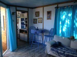 a living room with a couch and a table at L'oiseau BLEU à CALVI in Calvi