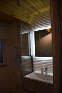 a bathroom with a sink and a mirror at Villa Šola in Kupres +7 photos
