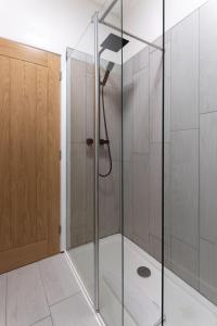 a shower with a glass door in a bathroom at Air Host and Stay - St Davids House Lovely 4 bedroom house 2 bathrooms in Liverpool