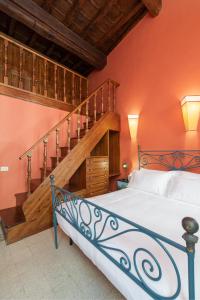 a bedroom with a bed and a staircase at Appartamento Tor Millina 4 Piazza Navona in Rome