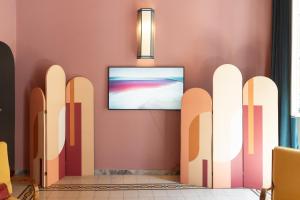 a room with a flat screen tv on a wall at Appartamento Tor Millina 4 Piazza Navona in Rome +13 photos