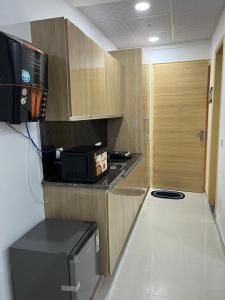 a kitchen with a microwave on a counter and a door at Gaur City Centre in Ghaziabad
