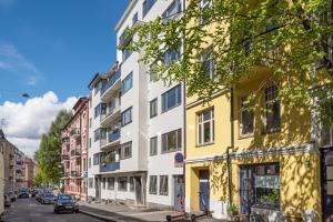a yellow and white building on a city street at Large apartment - Luxurious neighborhood - 8 pax in Oslo