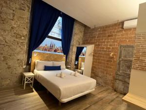 a bedroom with a large bed with a window at Happy People Plaza España Apartments in Barcelona