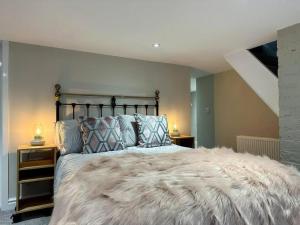 a bedroom with a large bed and two night stands at Birkdale Retreat in Southport