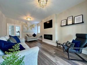 a living room with a couch and a fireplace at Birkdale Retreat in Southport