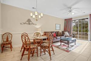 a living room with a table and chairs and a couch at The Havens 1512 in North Myrtle Beach