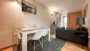 a kitchen and living room with a table and chairs at Almada Apartments 468 in Porto