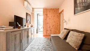 a living room with a couch and a television at Almada Apartments 468 in Porto