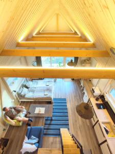 an overhead view of a living room with wooden ceilings at Modern Sauna Cabin in Horse Ranch in Lieplaukė