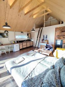 a large room with a bed and a kitchen at Modern Sauna Cabin in Horse Ranch in Lieplaukė
