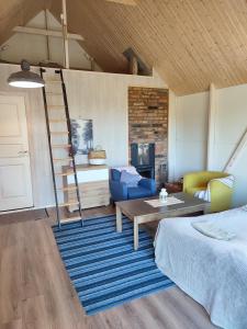 a room with a bed and a table and a ladder at Modern Sauna Cabin in Horse Ranch in Lieplaukė