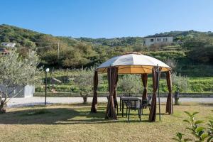 a gazebo with a table and chairs under it at Laurus Cilento Relax BeB in Laureana Cilento