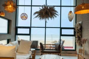 a living room with a large window with a view of the beach at Blpl Cabane A luxury beach house in Karachi