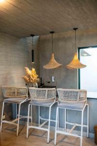 a group of chairs and tables in a room with lights at Blpl Cabane A luxury beach house in Karachi