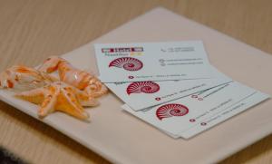 a plate of food with a ticket and a starfish at Nautilus Hotel in La Spezia