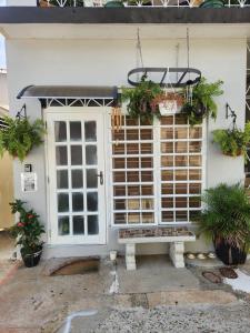 a house with a bench in front of a door at MI CASITA BOHO GREEN in Guayama