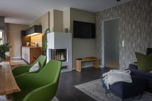 a living room with a couch and a fireplace at Deine Genuss-Auszeit in Asendorf