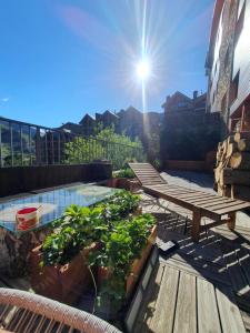 a patio with a picnic table and a pool at UNIQUE 57m2 Terraza BBQ magica vista Quer in Canillo