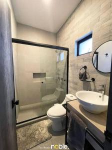 a bathroom with a shower and a toilet and a sink at Maravilloso Departamento in Chihuahua