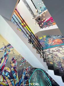 a room with a painting on the ceilings and stairs at Maravilloso Departamento in Chihuahua