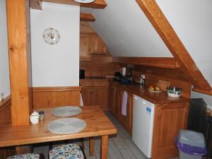 a kitchen with wooden cabinets and a wooden table at Willa pod Lipami Jagniątków in Jelenia Góra-Jagniątków