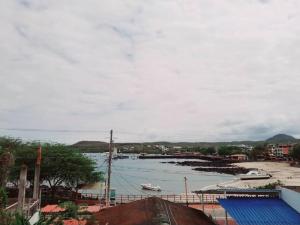 a view of a harbor with a boat in the water at Casa Playa Los Marinos in Puerto Baquerizo Moreno