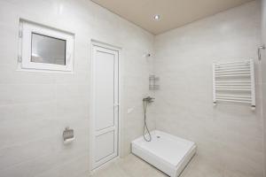 a white bathroom with a toilet and a window at The heart of the ancient district 3BD-2BATH apartament in Tbilisi City