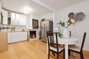 a kitchen and dining room with a table and a fireplace at Large apartment - Luxurious neighborhood - 8 pax in Oslo