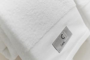 a close up of a white towel on a bed at Hotel Carris Marineda in A Coruña