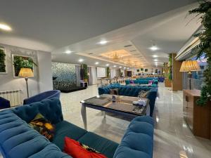 فندق سي بيرل في باكو: غرفة معيشة مع أرائك زرقاء وطاولة