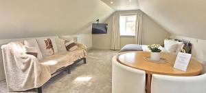 a living room with a couch and a table at Apple Tree Place B&B in Tadley